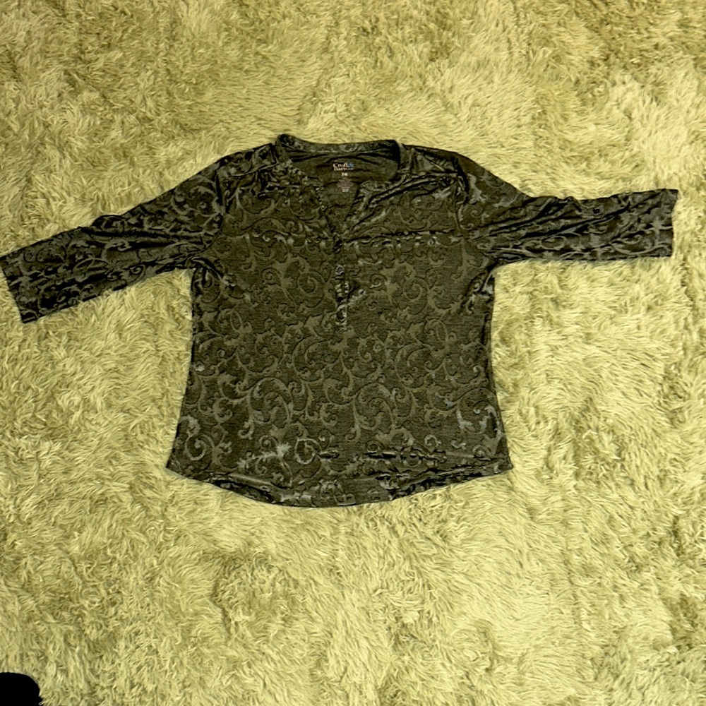 A green semi-button up shirt with vintage details